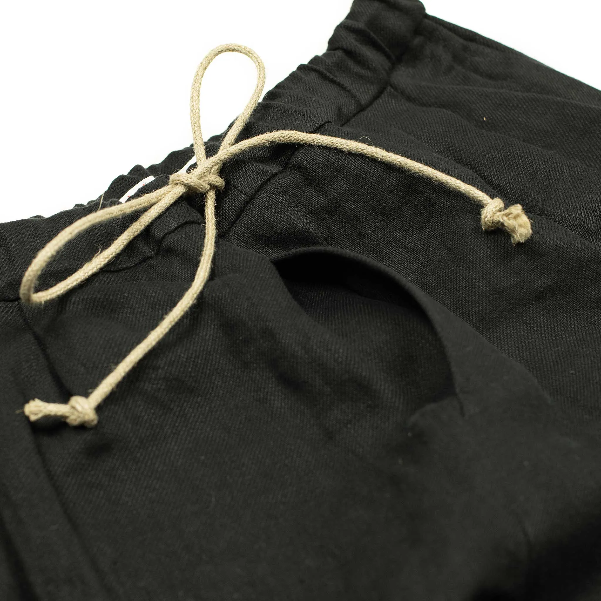Pleated drawstring trousers in soft black washed linen twill
